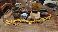 Wide view of all plant pots and macrame holder arranged on wooden table