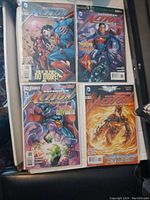 Four DC Comics Action Comics issues displayed, showing front covers of each comic featuring Superman and other characters.