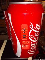 Side view showing Coca-Cola branding and control panel on the fridge rear.