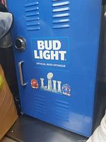 Close-up of the front door of a blue Bud Light branded fridge with Super Bowl LIII graphics and logos.