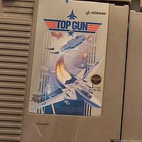 Top Gun NES game cartridge showing original label artwork and intact cartridge body.