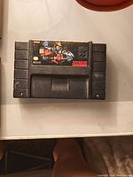 Photo showing a gray SNES cartridge labeled Killer Instinct with colorful character artwork and Super Nintendo branding.