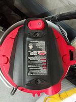 Top view of Jobmate shop vac showing power switch and information label.