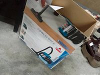 Boxed Bissell PowerForce vacuum cleaner seen from outside showing product images and brand