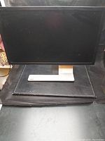 Front view of the Acer monitor showing the widescreen black display and the silver base stand.