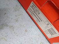 Close-up of the Nike shoe box label indicating size 9.5 and model Vapor X.