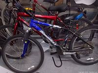 Photo of the Diamondback mountain bike showing the entire side profile of the bike in a storage area with another bicycle in the background.