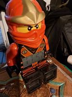 Front view showing the digital time display on the torso of the Ninjago ninja alarm clock figure.