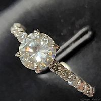 Close-up of center round brilliant diamond and prong setting.