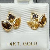 Front view of both stud earrings on display card marked 14KT. GOLD