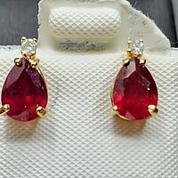 Front view of both earrings on display card showing pear-shaped rubies and round diamonds