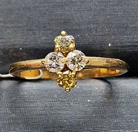 Front view of ring showing four-stone cluster