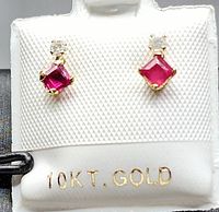 Front view of both earrings mounted on display card indicating 10k gold hallmark.