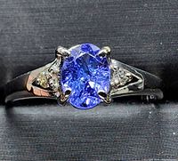 Front view of ring showing oval tanzanite center stone and diamond accents