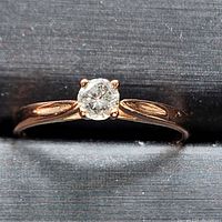 Front view of ring showing solitaire diamond and band