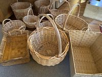 Photo capturing the full assortment of baskets arranged on the floor showing varying sizes, shapes, and handle presence.