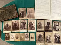 Leather-bound photo album, 18 vintage cabinet card photos arranged showing men, women, couples in formal 19th century attire, and part of a teachers record book opened with handwritten and typed pages.