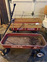 Two Radio Flyer wagons side by side showing wood and rusted metal versions.