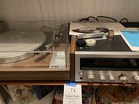Front view showing Yamaha turntable on left and Kenwood receiver on right with accessories on top