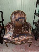 Front view of the armchair showing overall shape, fabric pattern and frame finish