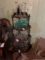 Full view of the wood corner shelf filled with glassware showing all four tiers.