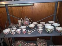 Shelf overview showing all porcelain items with matching chintz floral pattern