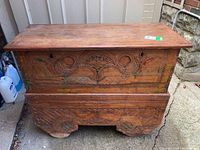 Front view of the antique Indonesian Java dresser showing carved decorations and wood patina.