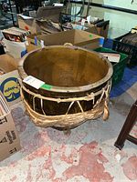 View of the large ceramic jar from above displaying interior and size relative to surrounding boxes.
