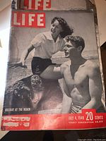 Photo showing cover of July 4, 1949 Life magazine with beach holiday scene