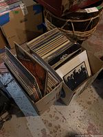 Two cardboard boxes filled with vinyl LP records