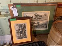 Three framed prints shown together with two smaller prints in front and a larger print in the back.