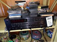 Full front view showing receiver with stacked cassette tapes on top