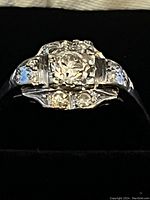 Front view showing round center diamond, baguette and accent diamonds