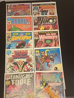 Overview photo showing 10 bagged and boarded comic books laid out in two rows of five, showing front covers with different Marvel series and titles.