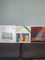 Three Monty Python vinyl record albums displayed on a surface, showing front covers of 'Another Monty Python Record,' 'Matching Tie and Handkerchief,' and 'Live at Drury Lane.'