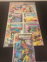 Photo showing nine comic books spread out, featuring Warlock Chronicles and Warlock and the Infinity Watch titles.