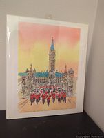Full view of the watercolor print in protective sleeve against a wall, showing the ceremonial guard band and historic building under a colorful sky.