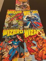 Five comic guides laid out on a black surface showing colorful superhero covers including Superman, Captain America, Iron Man, and X-men.