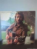 Front cover of Gordon Lightfoot's Don Quixote vinyl record showing a photo of the artist with a guitar outdoors.
