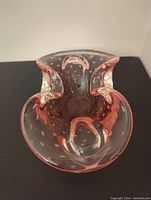 Top-down view of the pink lead crystal candy dish showing its wavy edges, bubble pattern inside, and the light pink cranberry coloration.