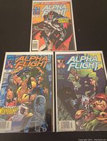 Photo showing three Marvel Alpha Flight comics: issues 2, 8, and 9, bagged and boarded, displaying their vibrant covers.