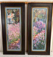 Full view of both framed watercolor prints side by side showing colorful garden scenes with flowers and dark wood frames.