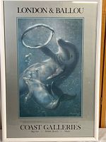 Front view of framed dolphin poster, showing full artwork and text with Dolphins playing underwater in blue-gray tones.