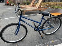 Full side view of the blue Diamond Back Outlook mountain bike with 17 inch frame. Tires flat, frame shows minor rust.