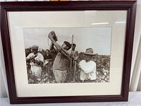 Framed sepia photo print of grape harvest with four workers in vineyard.