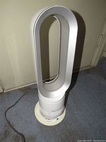 Dyson HP02 Pure Hot + Cool front full unit view showing oval loop air amplifier and base.