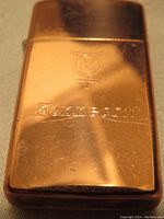 Front side of copper lighter showing Kennecott logo and name engraved