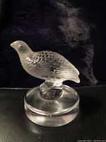 Full view of frosted crystal quail partridge figurine atop clear round base, showcasing bird details and shape.
