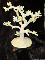 Front angle showing detailed tree branches with clover leaves and textured base