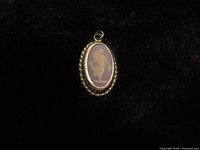 Front view of the oval Wedgwood blue cameo pendant with sterling silver twisted rope border, showing the white classical figure relief on blue background